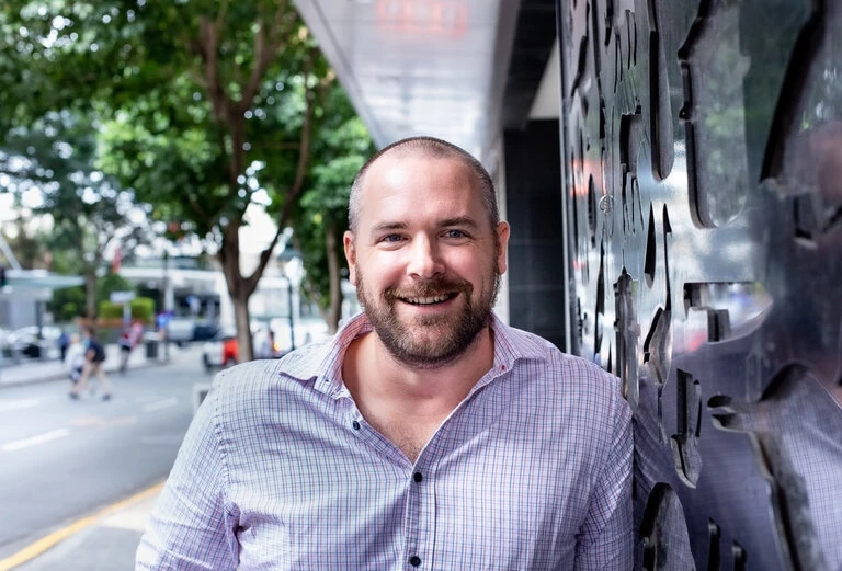 Rob Lovegrove smiling beside a city street